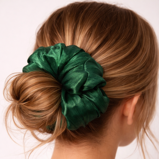 Green scrunchie in a bun on a person with a white background
