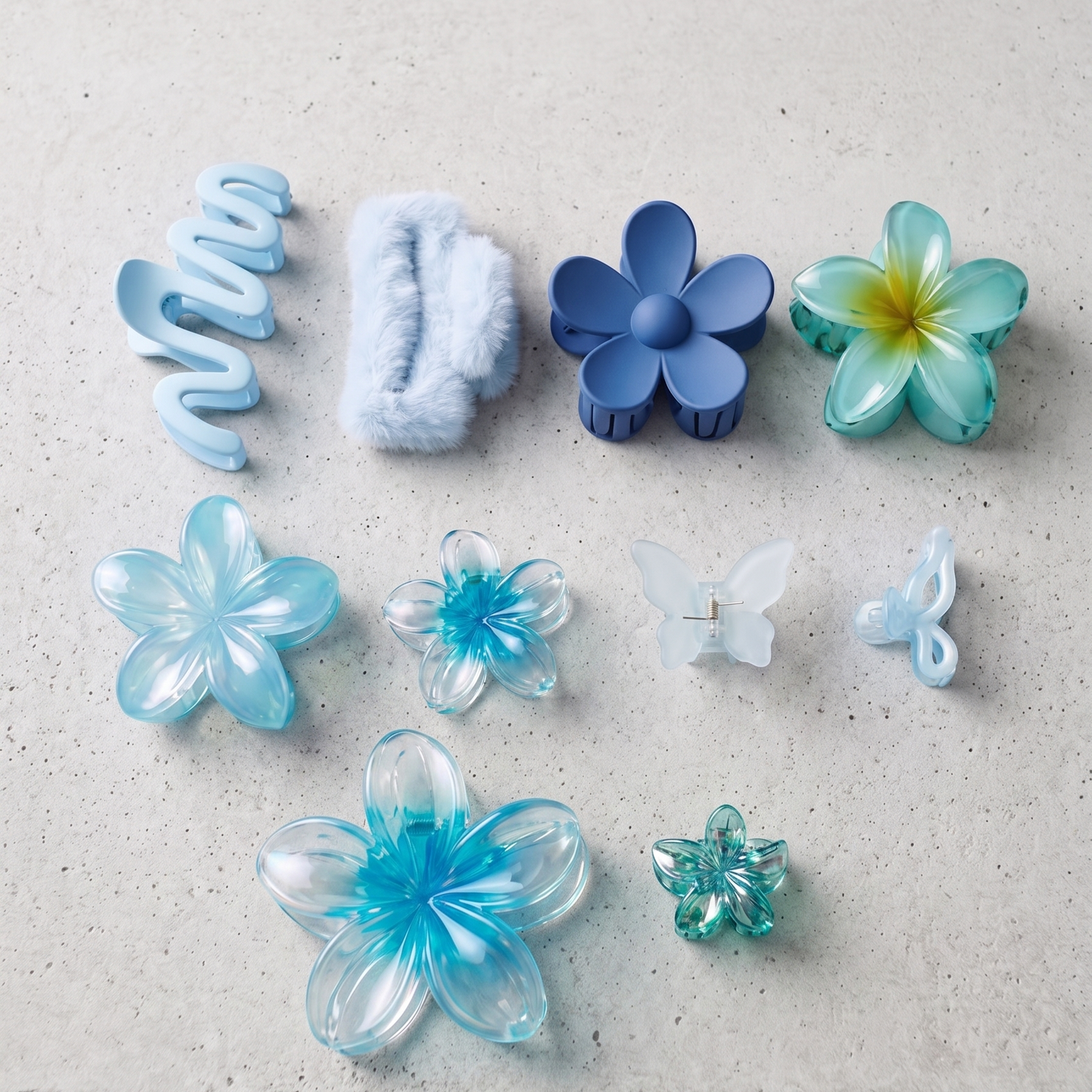 Collection of blue and clear plastic hair accessories on a light gray surface
