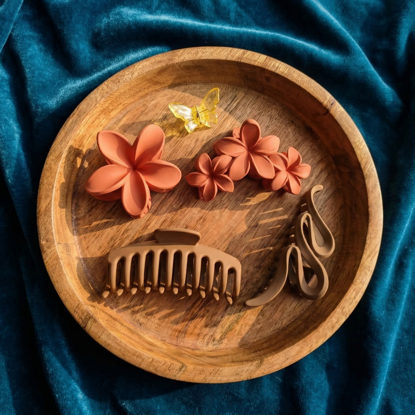 Wooden bowl with floral designs and 'LOVE' on a blue fabric background