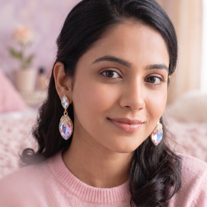 Woman wearing pink sweater and earrings with a blurred background