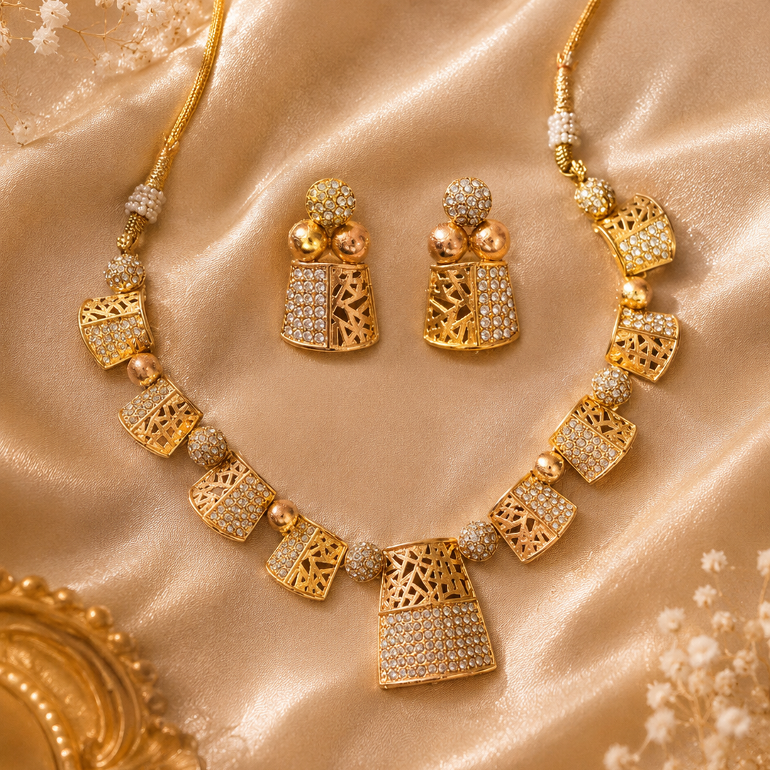 Gold necklace and earrings on a satin surface with small flowers