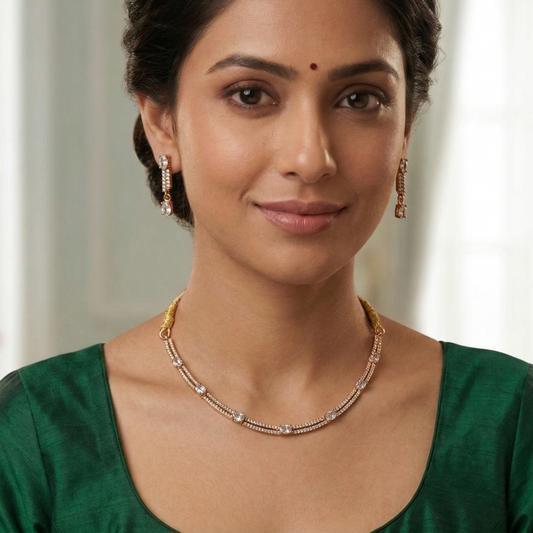 Woman wearing a green saree with gold jewelry against a blurred indoor background