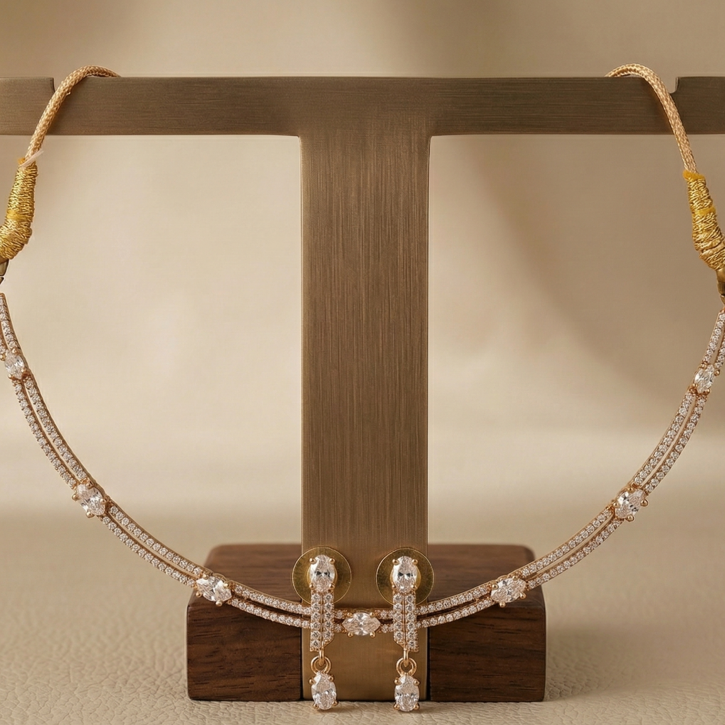 Necklace and earrings on a wooden stand against a beige background