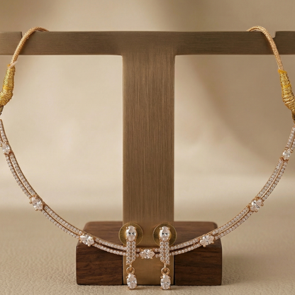 Necklace and earrings on a wooden stand against a beige background