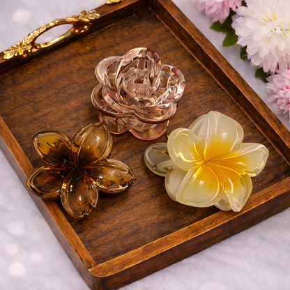 Three decorative flowers on a wooden tray with a floral background