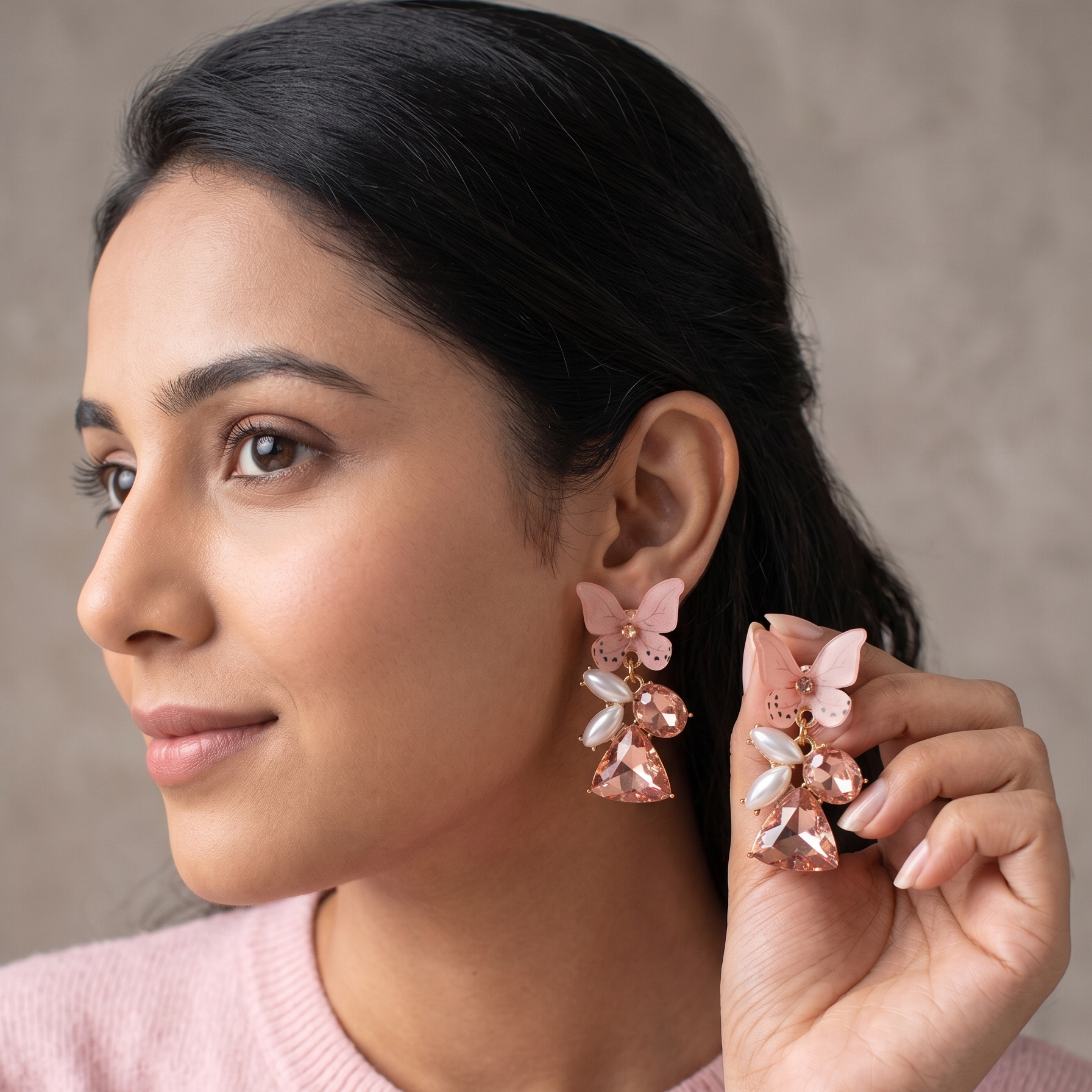 Woman wearing pink floral earrings against a neutral background