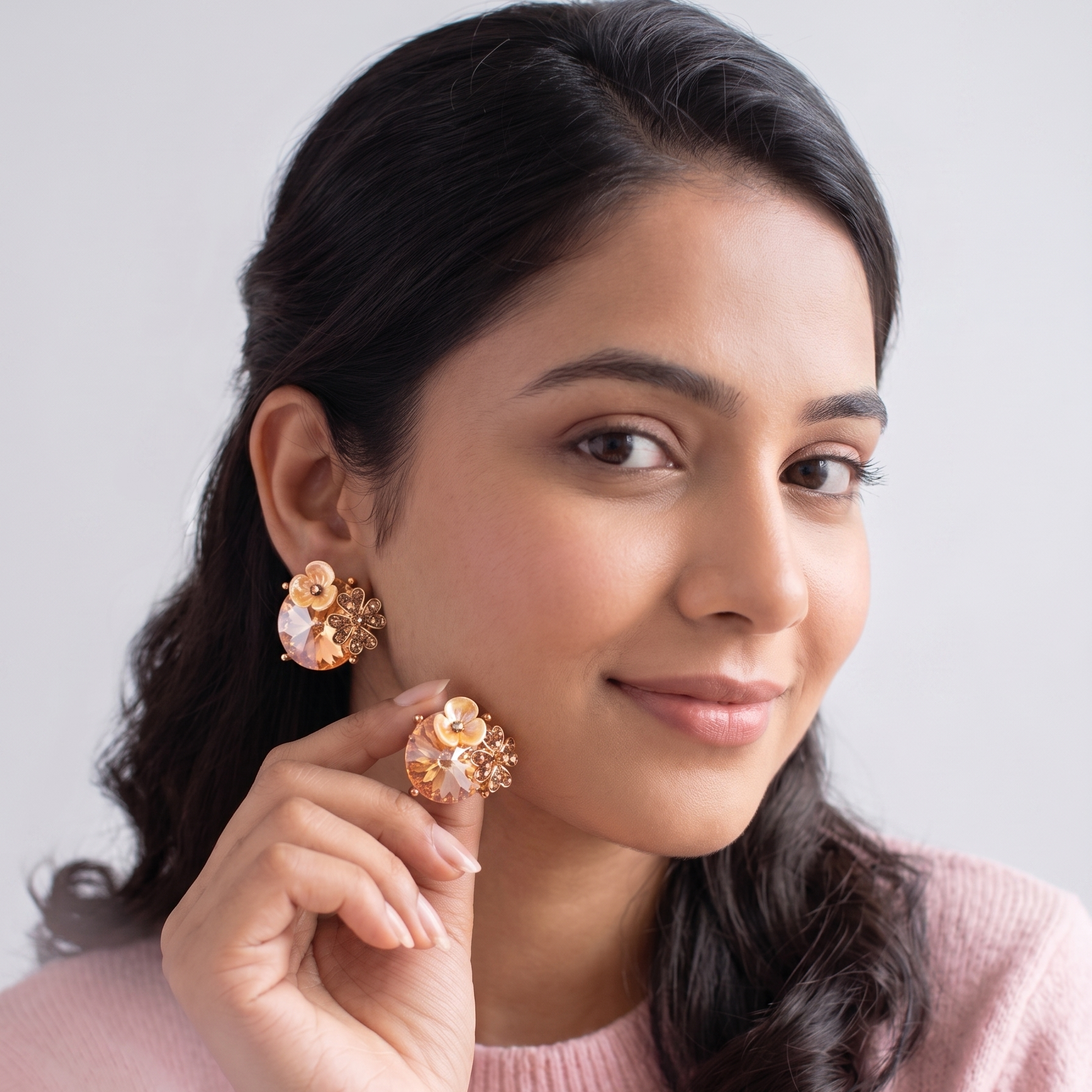 Woman wearing floral earrings against a light background