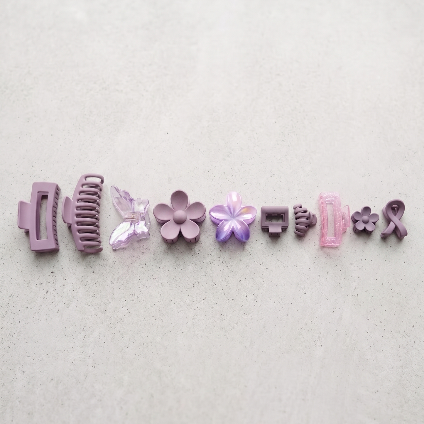 Set of various hair clips on a light gray background