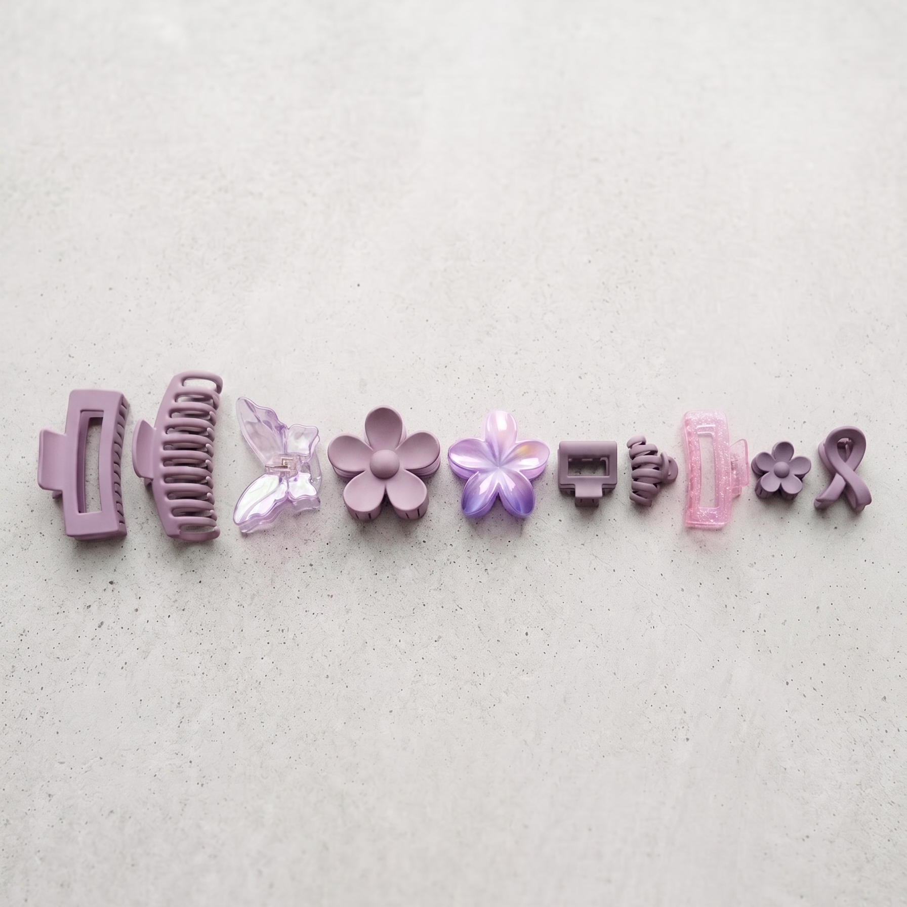 Set of various hair clips on a light gray background