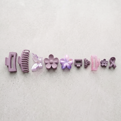 Set of various hair clips on a light gray background