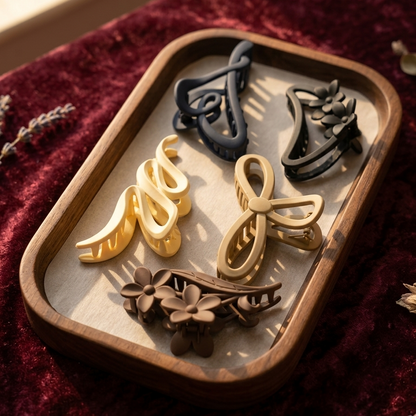 Set of decorative earrings on a wooden tray with a red fabric background