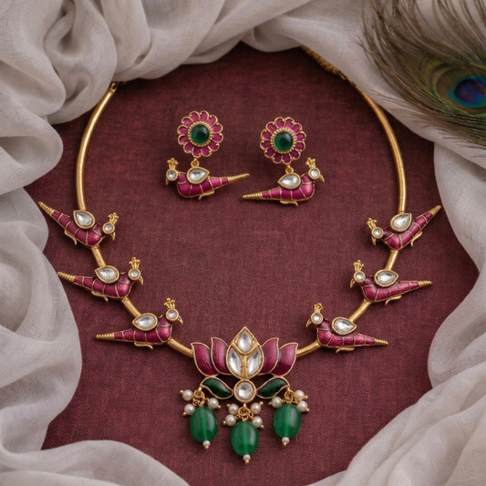 Ornate jewelry set with necklace, earrings, and ring on a maroon background
