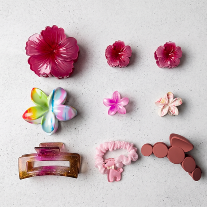 Colorful hair accessories including flowers and clips on a light gray background