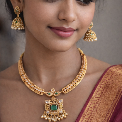 Woman wearing gold jewelry with a plain background