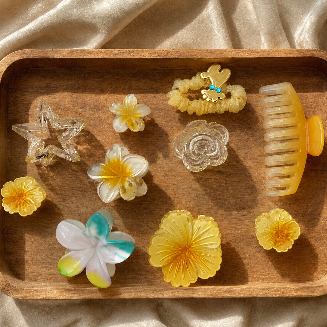 Wooden tray with decorative items including flowers and a brush on a beige fabric background